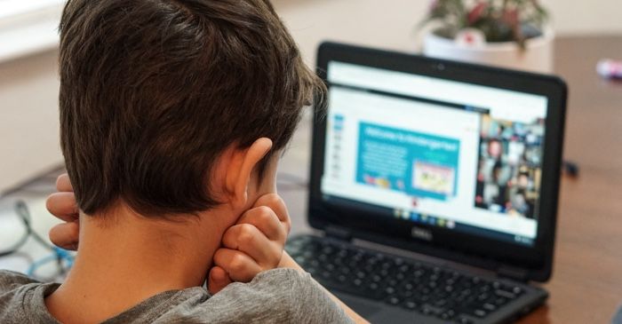 child working on a laptop