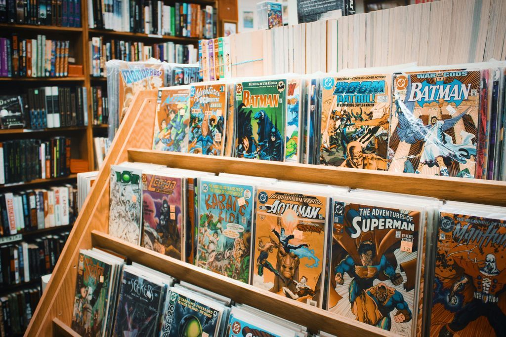 assorted comic book on brown wooden shelf