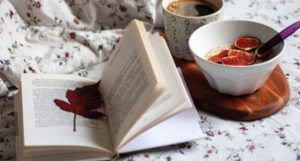 open book with fall leaf bookmark coffee and breakfast