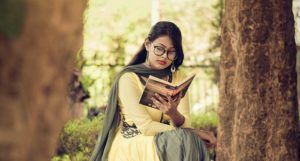 History of Reading. A woman dressed in a yellow and gray sari, reading a book. Photo by Joy Deb from Pexels Link: https://www.pexels.com/photo/woman-reading-book-1580272/?utm_content=attributionCopyText&utm_medium=referral&utm_source=pexels