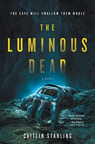 cover of The Luminous Dead by Caitlin Starling; illustration in shades of blue of a glove clinging to the edge of a pit