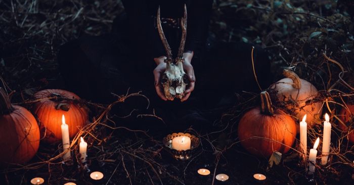 witch with pumpkins and skull