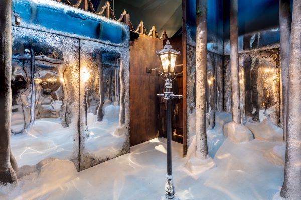 Mirrors, trees and a streetlamp in an indoor winter scene