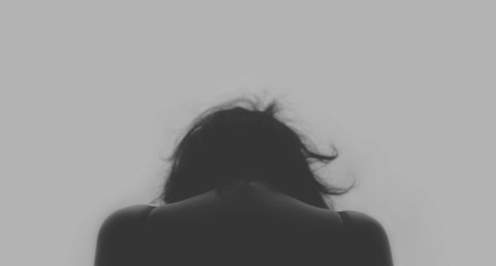 black and white image of a woman's head from behind https://bookriot.com/tag/mental-illness/