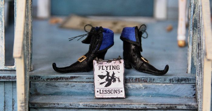 witch shoes with "flying lessons" sign on porch steps