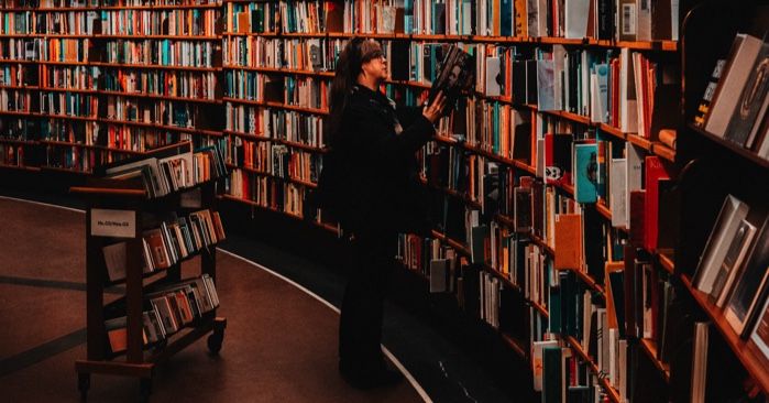 woman browsing books in a library