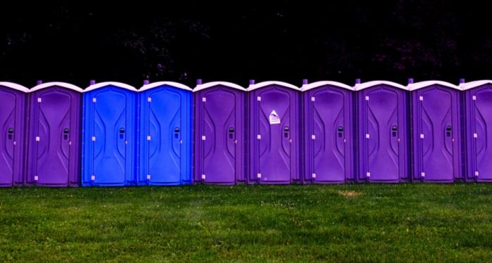 purple and blue portapotties in a line outside