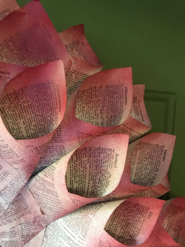 Close up picture of book pages spray painted red