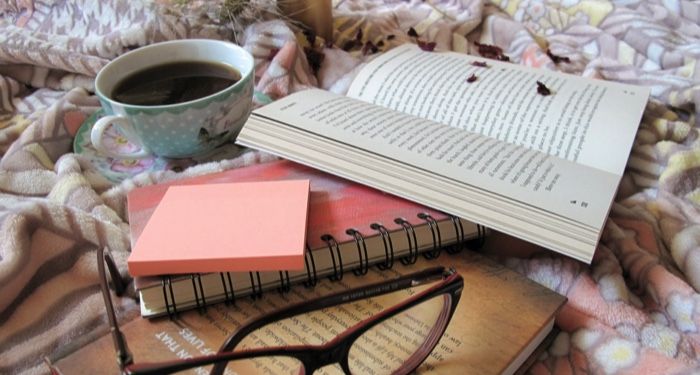 image of an open book next to a teacup and eyeglasses https://unsplash.com/photos/u59gG_FIGIo
