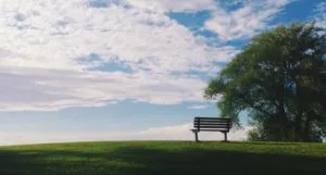 image of an empty bench on a hillside against a blue sky https://unsplash.com/photos/EBB45rCSjrU