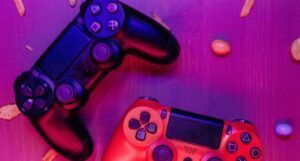 stock photo of two video game controllers under purple lighting