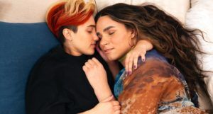 A transmasculine gender-nonconforming person and transfeminine non-binary person sleeping together in bed for queer lgbtq roman
