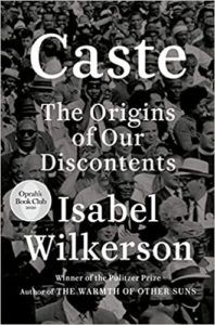 the cover of Caste; a black and white overhead photo of a crowd
