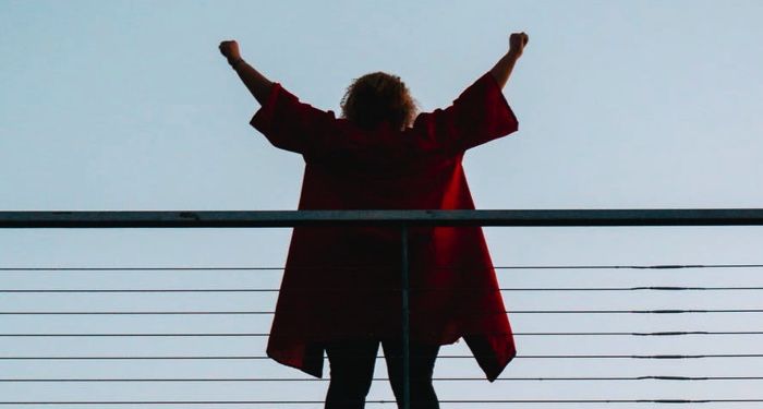 https://www.pexels.com/photo/back-view-photo-of-standing-woman-with-her-hands-raised-2836705/