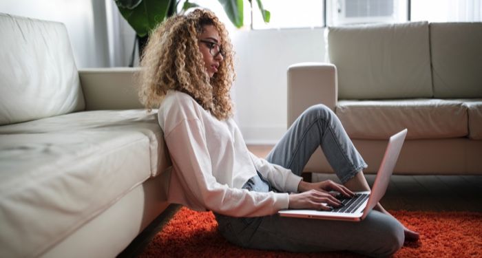 woman writing or working on a laptop at home