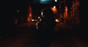 image of woman dressed in black and holding a pistol on a street at night https://unsplash.com/photos/G5nl9_YEXuc