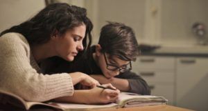 image of a young boy and a woman/parent figure focused on a textbook https://www.pexels.com/photo/focused-students-doing-homework-at-home-3769995/