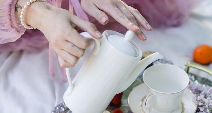 Hands pouring tea