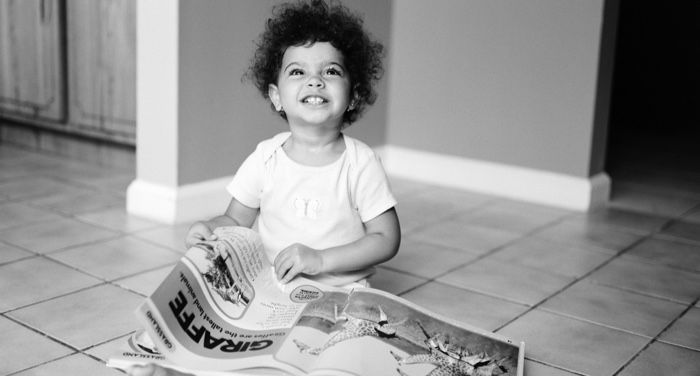 child reading a book at home