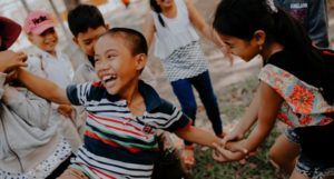 image of kids playing on grass https://unsplash.com/photos/0DPyb8t_KfI