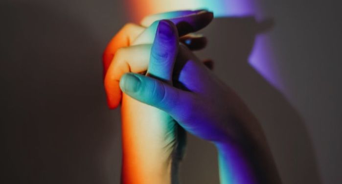 image of clasped hands bathed in rainbow-colored light https://www.pexels.com/photo/photo-of-persons-doing-holding-hands-3693920/