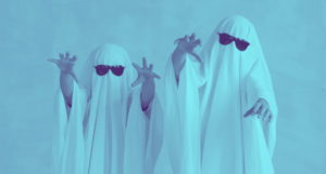 two people dressed as ghosts with white sheets and sunglasses