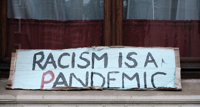 racism is a pandemic sign https://unsplash.com/photos/zswLbyR_b58
