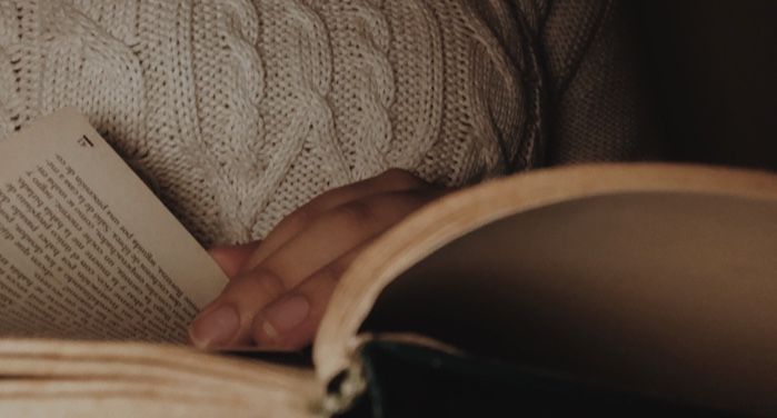 image of a person turning pages of an open book https://unsplash.com/photos/9azhqos3V_o
