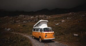 orange vw van on a deserted road