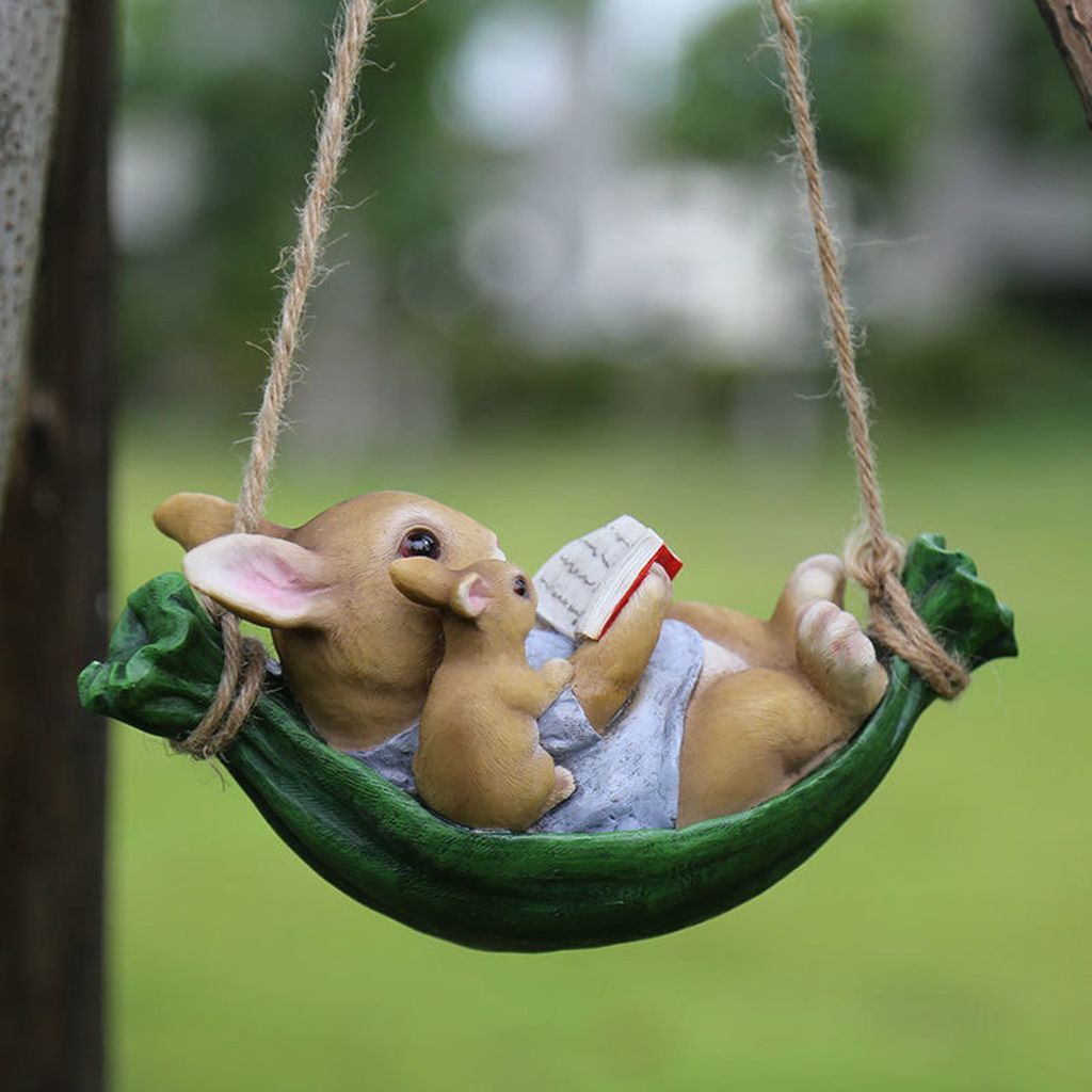 Reading rabbits on swing figurine