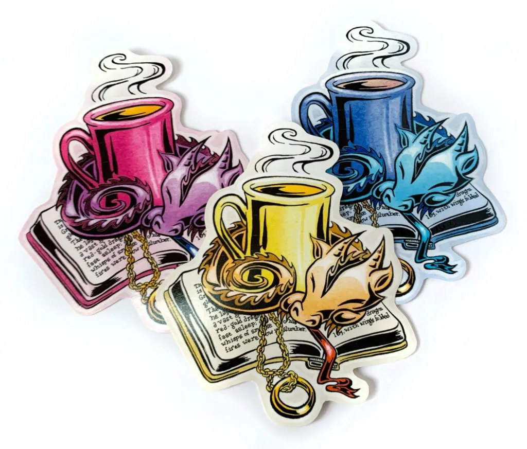A sticker of a dragon curled up around a coffee cup on an open book