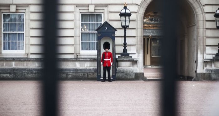 royal guard standing beyond the gates of buckingham palace