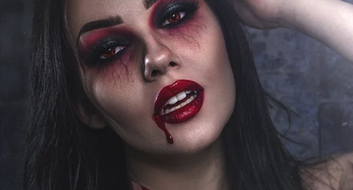 image of a woman with red and black smokey eye makeup, red lipstick, and makeup that looks like blood dripping from her mouth https://unsplash.com/photos/HWUiNmpeHbg