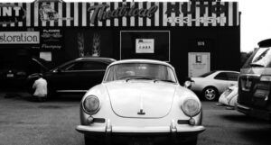 1950s car in front of a shop in black and white