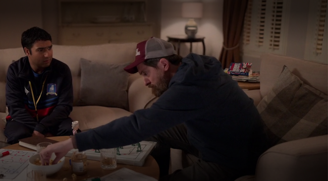 A still of episode 10. Beard and Nathan are sitting in Ted's living room. In the background is the Rhyming Slang book, opened.