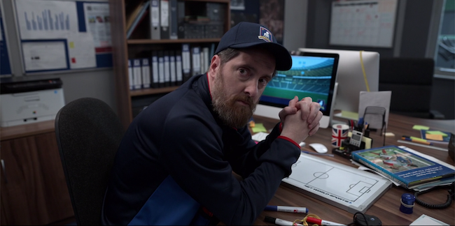 Beard looks upset at his desk