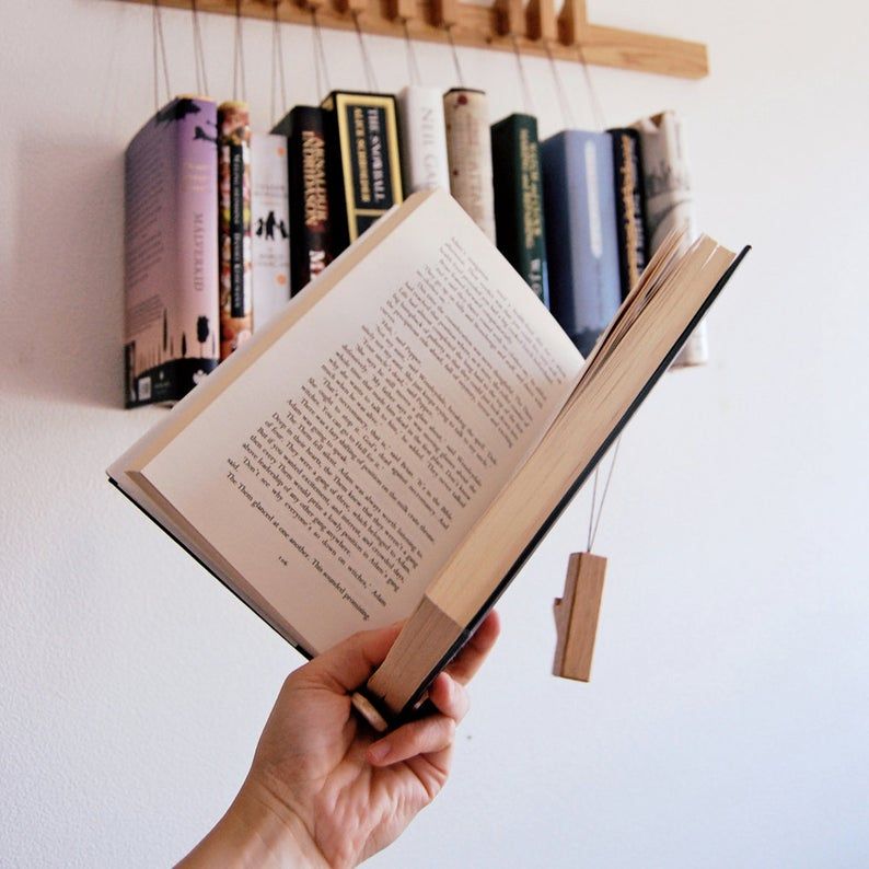 Custom book rack, with an open book in front using the pin as a bookmark