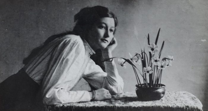 black and white photo of woman at desk