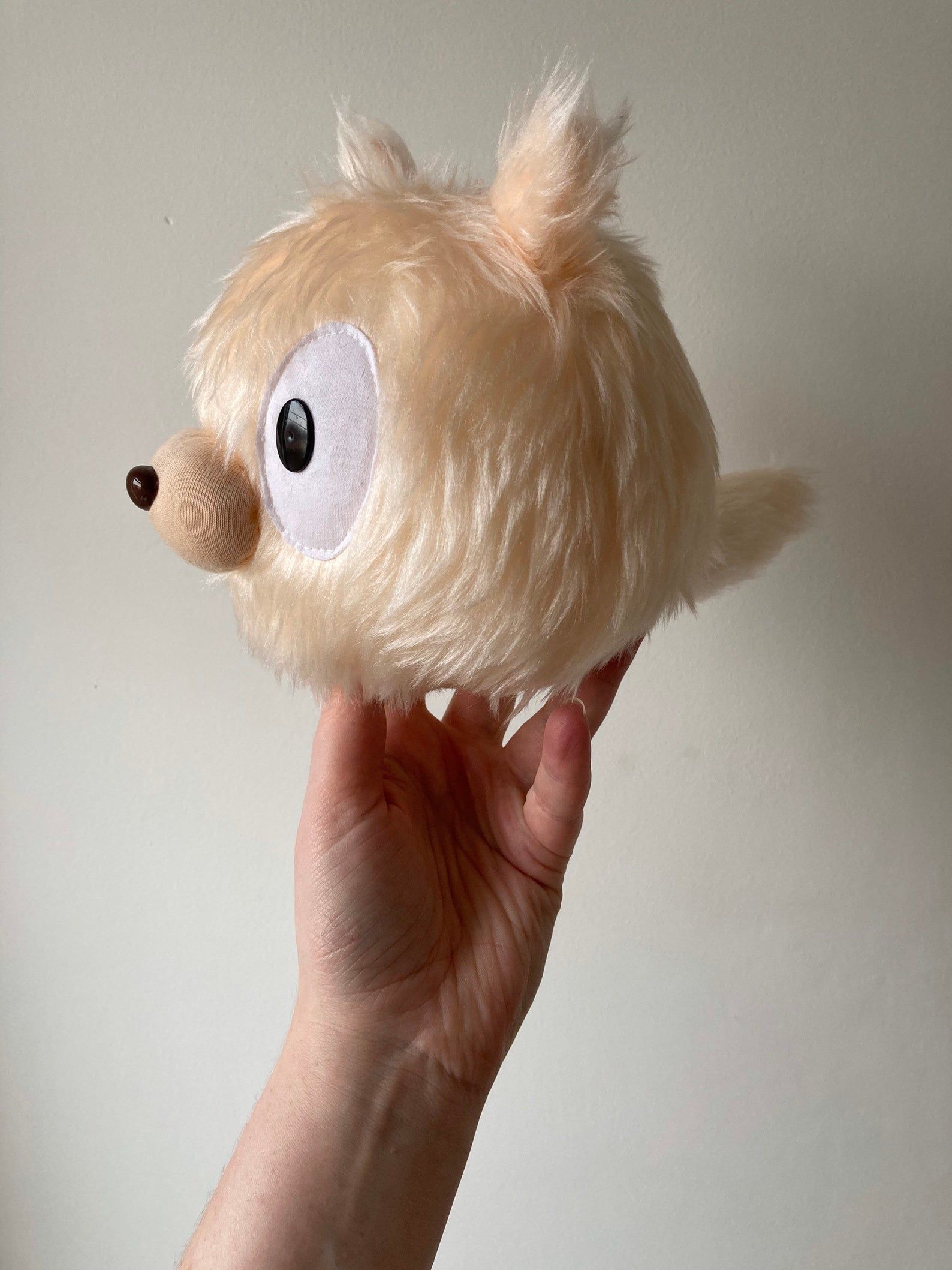 Pale peach Woff plushie from Hilda cartoon