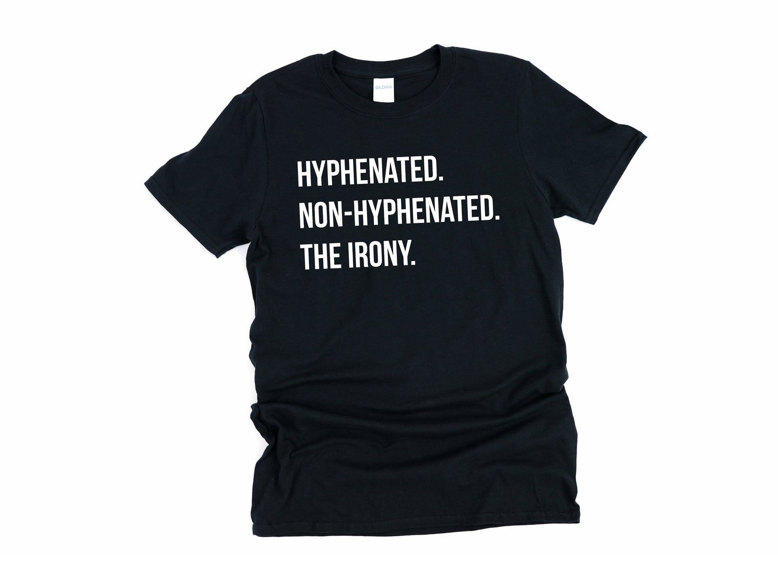 A black t-shirt that reads "Hyphenated. Non-hyphenated. The irony." in white lettering, all caps.