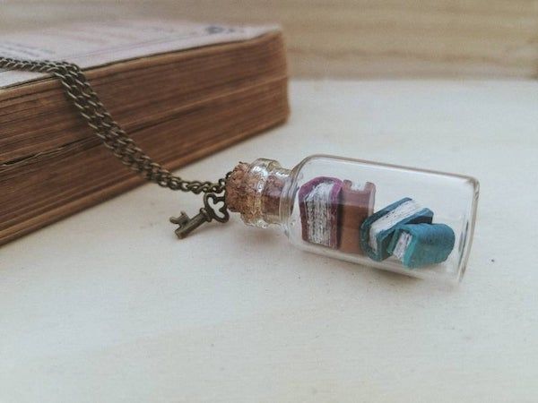 mini books in a vial with key charm