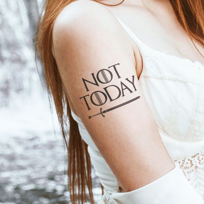 Image of a Game of Thrones-inspired temporary tattoo on a biceps that says “Not Today” and is underlined by a sword