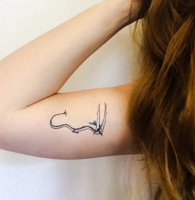 Image of a person's arm with a Smaug the dragon temporary tattoo on their bicep