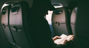 photo of someone reading on an airplane