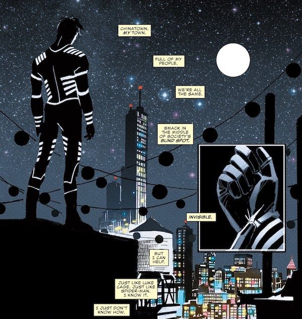 Two panels from All-New, All-Different Marvel Point One #1. Blindspot stands on a roof in costume, facing away from us and looking out over Chinatown. In a smaller inset panel, he presses a button on his wrist to turn his suit on.
Narration boxes: "Chinatown. My town. Full of my people. We're all the same. Smack in the middle of society's blind spot. Invisible. But I can help. Just like Luke Cage. Just like Spider-Man. I know it. I just don't know how."