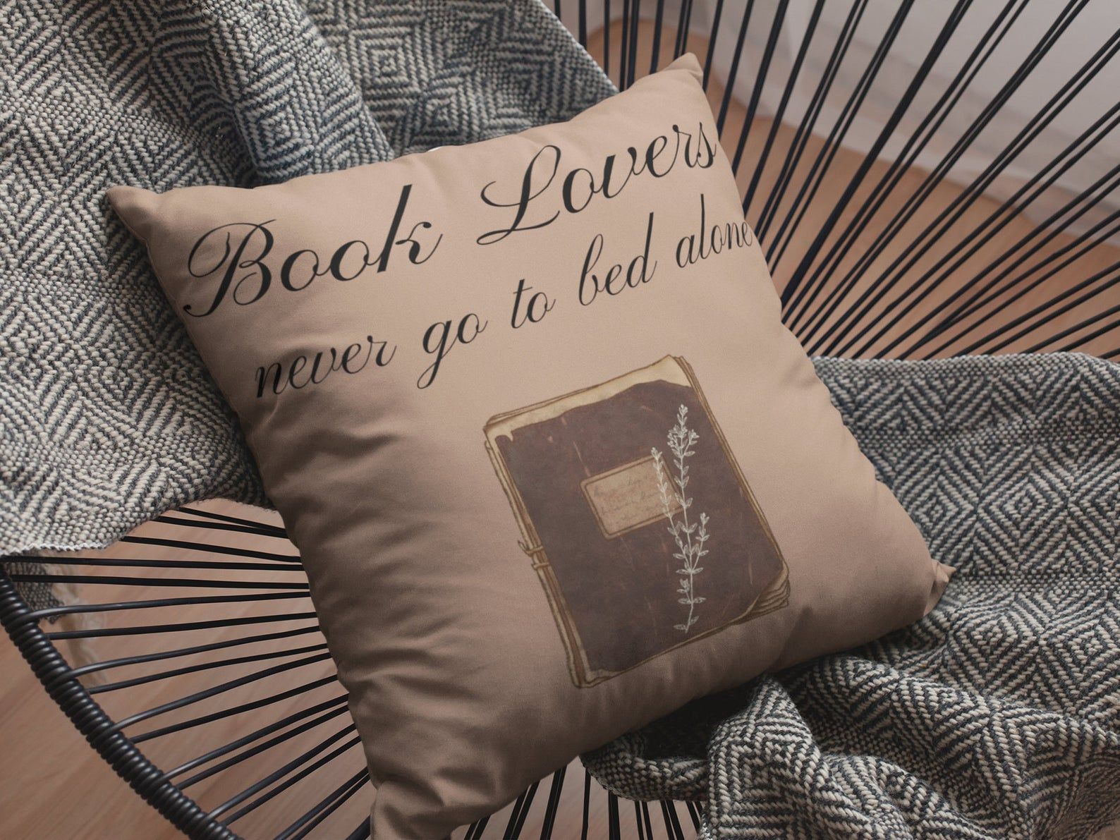 Image of brown pillow reading "book lovers never go to bed alone."