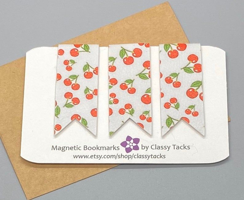 Set of three magnetic bookmarks featuring cherries on a white background. 