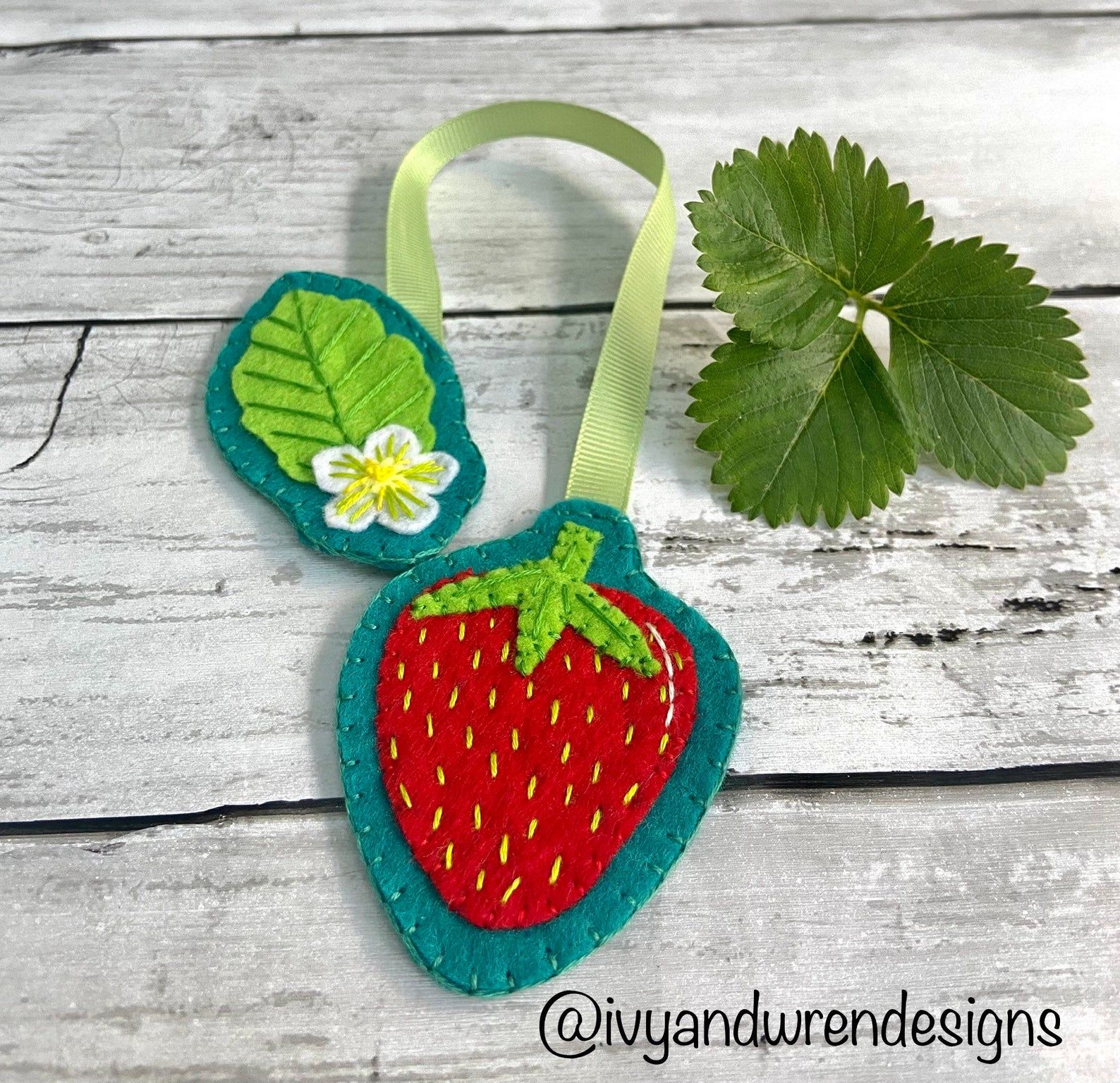 Image of a bookmark that is in the shape of a strawberry. 