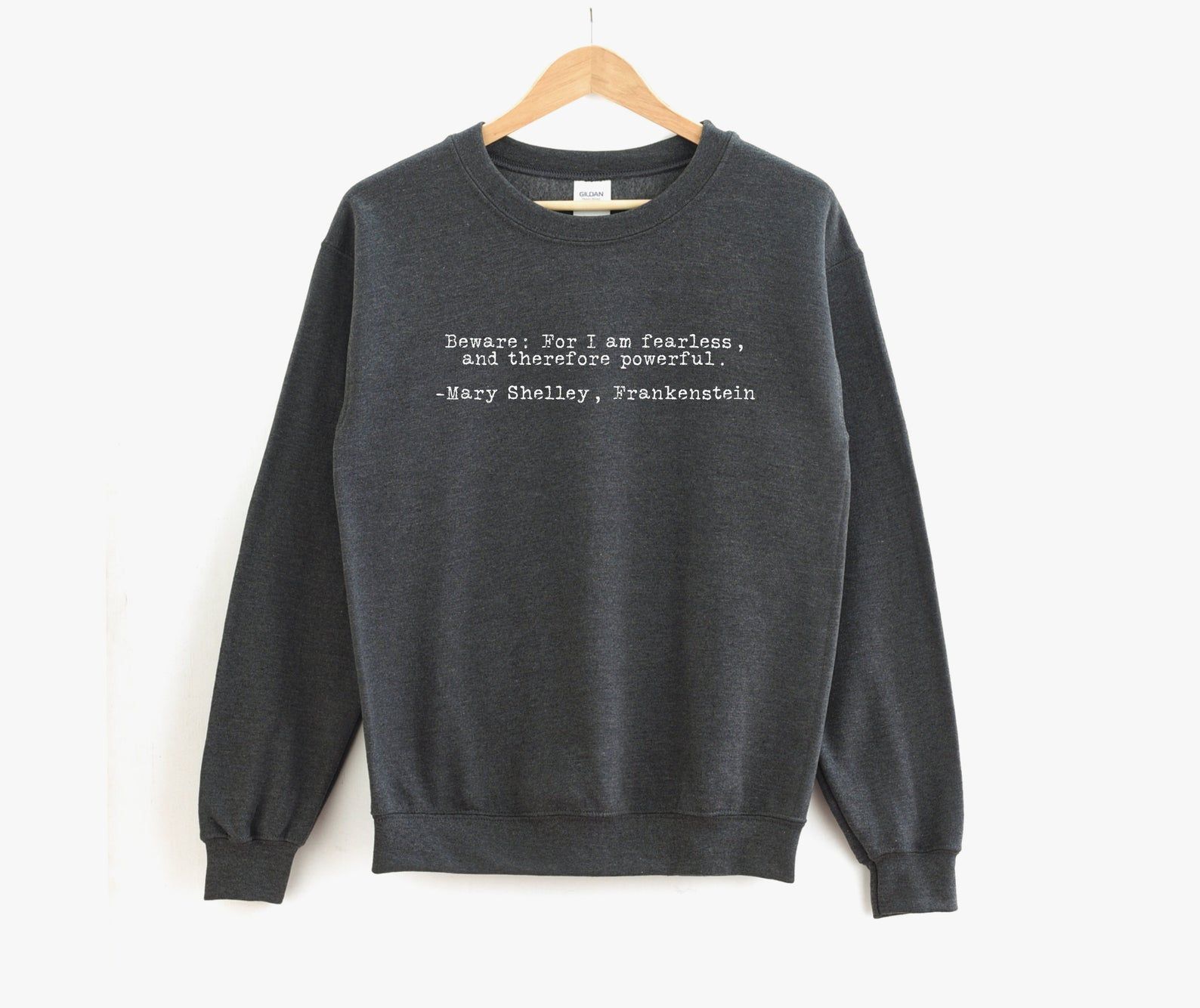 Image of gray sweatshirt featuring Mary Shelley's Frankenstein quote "Beware; for I am fearless, and therefore powerful."