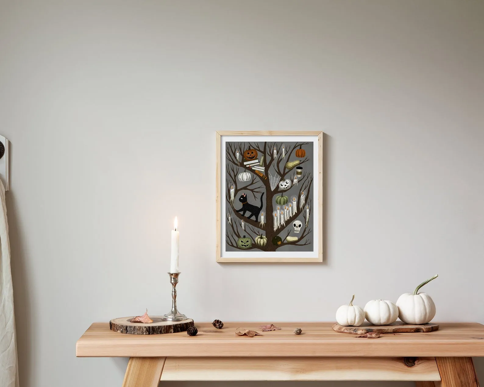 Image of spooky tree art, with branches featuring books, skeletons, ghosts, cats, and pumpkins.